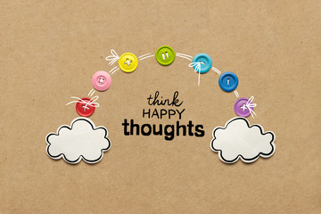 Happy thoughts / Creative concept photo of a rainbow and clouds made of paper on brown background.