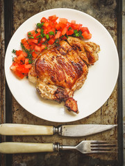 portion fresh pork steak with tomato salsa (salad with tomato and greens)