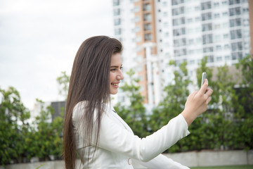 Fototapeta premium Women video calling on her smart phone