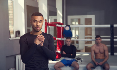 Man boxer. Male athlete before a workout in the gym.