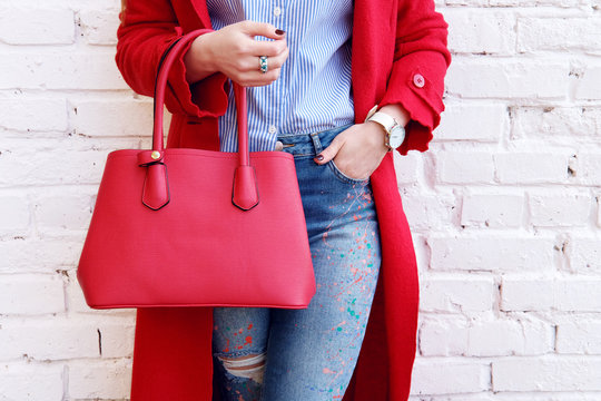 Fashion autumn outfit woman in red coat with leather bag