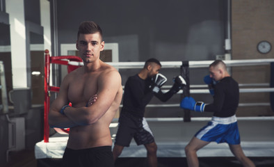 Fototapeta na wymiar Male boxers. Taking a box in the gym. Male kind of relaxation. Sports training.