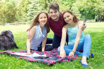 Group of friends - one man and two women. The joint rest and picnic. Life style.