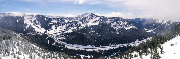 Panorama of Snowy Mountain Road and Winter Sports Resort in Pacific Northwest Forest © openrangestock