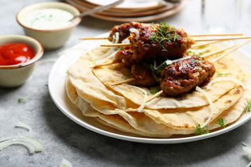 kebabs on skewers with pita