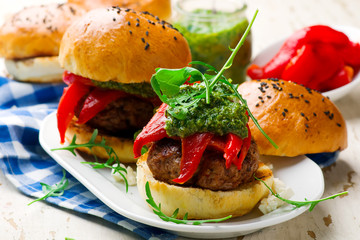 feta stuffed turkey burgers with arugula pesto and roasted red peppers.