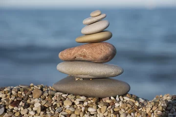 Foto op Plexiglas gestapelde stenen aan de kust © twanwiermans