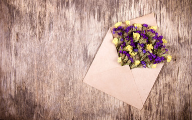 Paper envelope with wildflowers. Romantic concept. Flower letter.