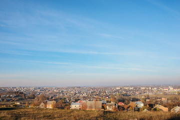 View on the beautiful colorful autumn landscape with a small village that consists of houses