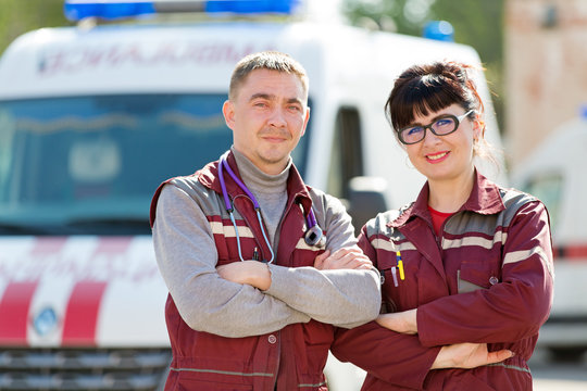 Emergency Medicine. Doctor with colleague paramedic on ambulance vehicle background