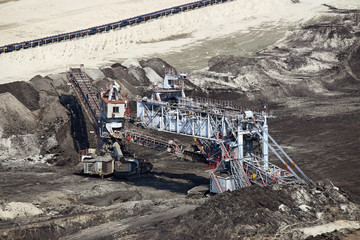 Open pit coal mine with excavator heavy machinery