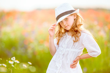 beautiful girl posing in a hat outdoor