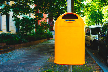 Fototapeta na wymiar orange garbage can on lantern