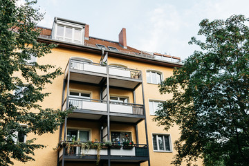 yellow apartment building with steel balcony