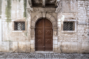 Entrance door of an ancient building in Porec town, Croatia, Europe.