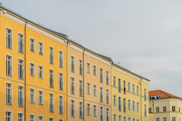yellow vintage houses in a row on cloudy day