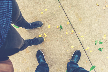 man and woman looking down to there shoes