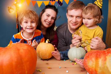 Fototapeta premium happy family mother father and two children in costumes on a celebration of Halloween