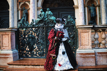 Fototapeta na wymiar Beautiful mask at St. Mark square during the carnival of Venice.