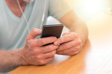 Man listening music with earphones, light effect