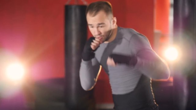A fighter goes throw a series of punches and lunges. 