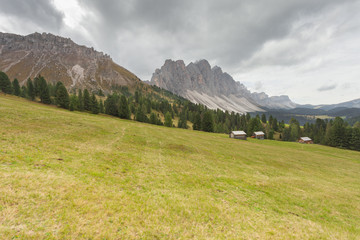 old hayloft in a pasture in Val di Funes at fall ( Dolomites - Odle group in the background )