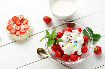 Delicious food for health rice vegan waffles with yogurt and fresh strawberries, strawberry with a yogurt on a white wooden background.Top view.Flat lay