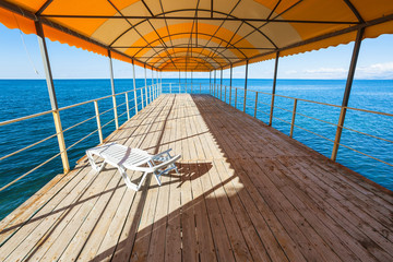 one plastic sunbed in outdoor solarium over sea