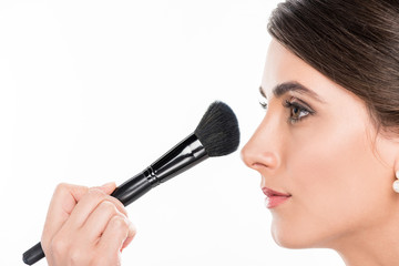 makeup artist applying powder
