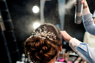 hairstylist fixating clients hairdo