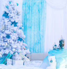 Blue and white christmas background with snowy tree