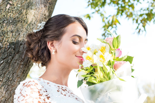 tender woman with bouquet of flowers