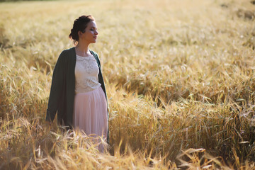 A young mother walk in wheat fields