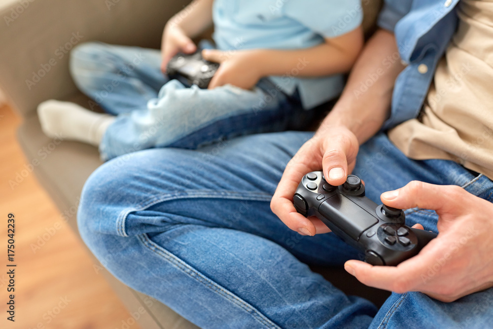 Poster close up of father and son playing video game