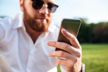 Close up image of bearded man in sunglasses and shirt