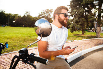 Side view of Happy bearded man in sunglasses