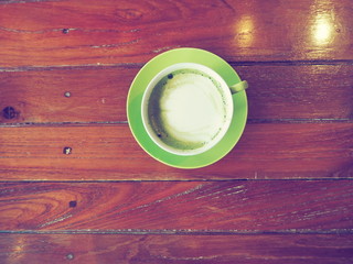 Coffee cup on wooden table .