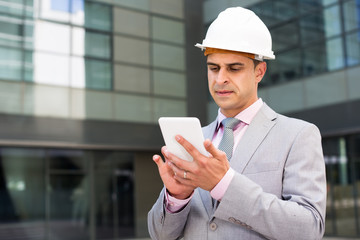 Confident businessman using cell phone
