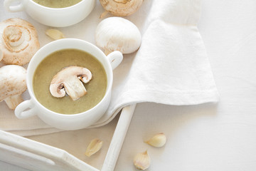 Two bowl with traditional mushroom soup cream on white table cloth