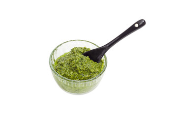 Pesto in the small glass bowl with small spoon