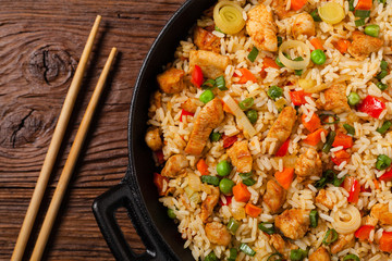 Fried rice with chicken. Prepared and served in a wok.