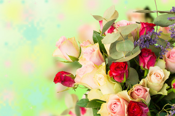 Top view on bouquet of pink and red roses on colorful background. 
