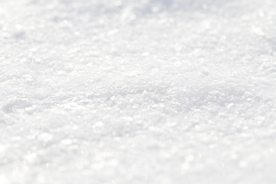 Background of a snowy white cover. The texture of the brilliant snow.