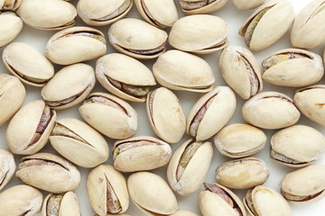 salted pistachio nuts background close up