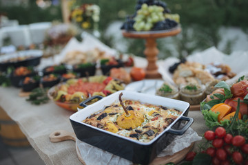 Outdoors fourchette table with traditional moldavian appetizers and fresh flowers