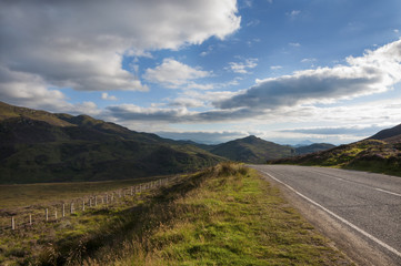 Fototapeta na wymiar Narrow country road in the Scottish Highlands, United Kingdom; Concept for travel in Scotland