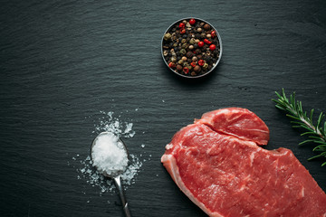 Raw beef steak with spices, top view, flatlay.