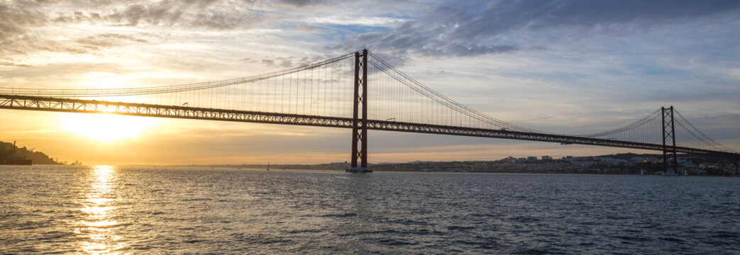 ponte 25 de abril bridge lisbon portugal with sundown panoramic view