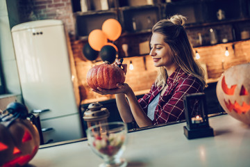 Woman with Halloween pumpkin