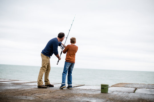 Father helping Son fish